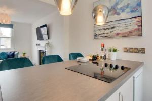 a kitchen with a large island in a room at Standout 2BD Coastal Cottages in South Devon in Shaldon
