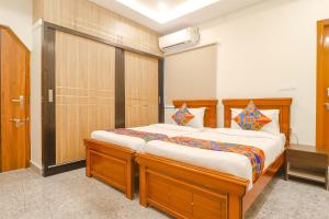 a bedroom with a large wooden bed in a room at Via RS Living - Nr TCS Deccan Park, Hitech City in Hyderabad