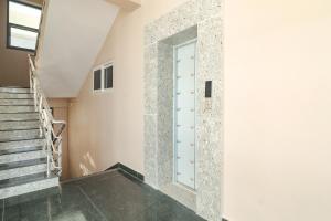a staircase with a glass door in a house at FabExpress RS Living - Nr TCS Deccan Park, Hitech City in Hyderabad