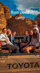 a group of women sitting in the back of a truck at Rum cloud camp in Wadi Rum