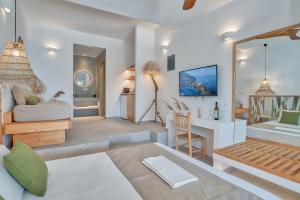 a living room with a bed and a desk at Marinatou Suites in Antiparos Town