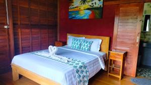 a bedroom with a bed with a white bedspread at Lake Batur Cottage in Bangli