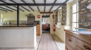 a large kitchen with a large counter and a room at Hullet Hall in Lakeside