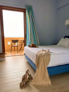 a bedroom with a bed and stuffed animals on the floor at Stella in the Village Junior Studio Sea View II in Plakias