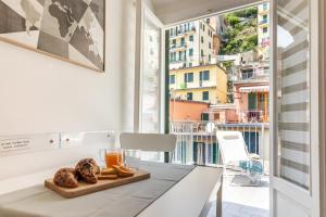a dining table with a view of the city from a balcony at WanderJohn penthouse 5terreparco in Riomaggiore