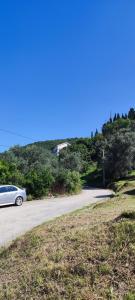 a white car parked on the side of a road at Lastva star in Donja Lastva