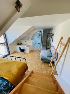 a bedroom with a bed and a staircase in a room at La LocaLuna in Civray-de-Touraine