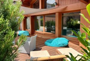 a large wooden deck with two chairs and avisor at Chalet Hôtel des 2 Gares in Saint-Gervais-les-Bains