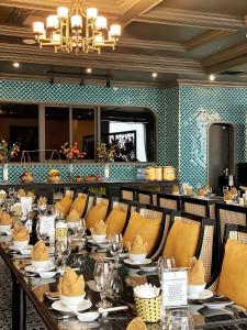 a dining room with a long table and chairs at MADELISE HOTEL&APARTMENT in Hai Phong