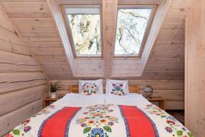 a bedroom with a bed in a wooden cabin at Comfortable 2 storey holiday home Ustronie Morskie in Ustronie Morskie