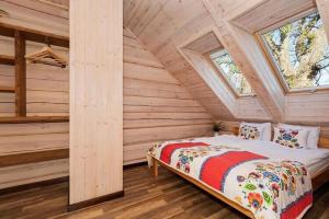 a bedroom with a bed in a log cabin at Comfortable 2 storey holiday home Ustronie Morskie in Ustronie Morskie