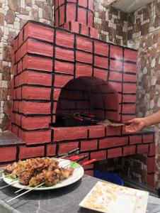 a brick oven with a plate of food on a table at Maison de vacances avec piscine privèe in Fez