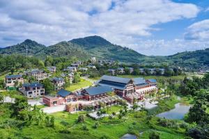 an aerial view of the resort with mountains in the background at Four Points by Sheraton Hainan, Qiongzhong in Qiongzhong