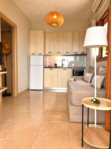 a kitchen and living room with a white refrigerator at Stella in the Village Studio Sea View in Plakias