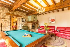 a living room with a pool table at La Glycine in Auxant