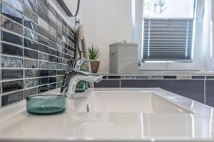 a bathroom sink with a green candle on it at Neues Ferienhaus an der Ostsee+Terrasse+Sauna in Surendorf +33 photos