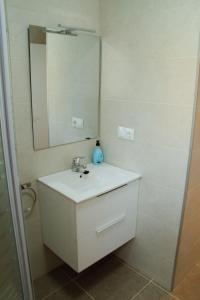 a bathroom with a sink and a mirror at Antich Apartment Deltebre in Deltebre