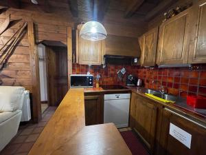 a kitchen with wooden cabinets and a counter top at Chalet Samoëns, 4 pièces, 5 personnes - FR-1-624-67 in Samoëns