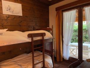 a bedroom with two bunk beds and a window at Chalet Samoëns, 4 pièces, 5 personnes - FR-1-624-67 in Samoëns