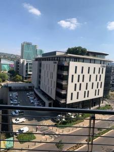 a view of a city with buildings and a parking lot at Entire Studio Apartment @MenlynMaine in Pretoria