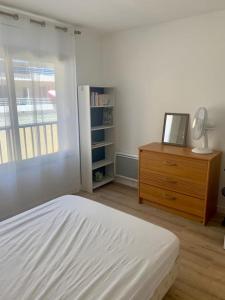 a bedroom with a bed and a dresser and a window at Le Roxane 2 bedroom apartment in the city-center of Antibes in Antibes