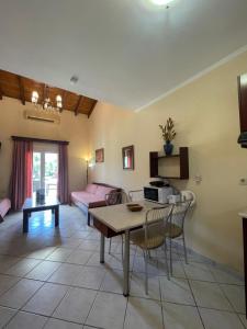 a living room with a table and a couch at L'Eremo Luxury Apartments in Roda