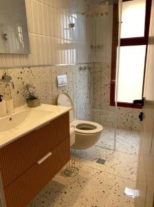 a bathroom with a toilet and a sink at GoodHouse 401 - Beautiful Flat in Center of Jerusalem in Jerusalem