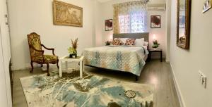 a bedroom with a bed and a chair at Apartment with a private garden in New Cairo in Cairo