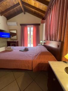 a bedroom with a bed with a red bedspread at L'Eremo Luxury Apartments in Roda