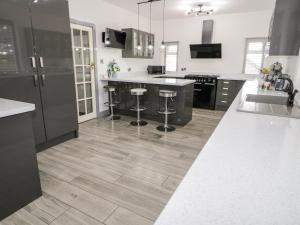 a kitchen with black and white cabinets and a counter top at The Moores in Prestatyn