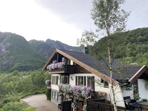 a house with flowers on the balcony of it at Romslig leilighet i Lofoten 