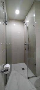 a bathroom with a shower stall and a toilet at RENTZONE88 in Manila