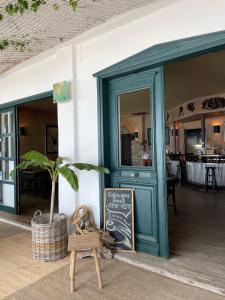 a restaurant with a sign in front of a door at Xenios Hotel in Pefkochori