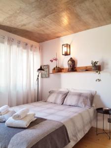 - une chambre avec un grand lit et un plafond en bois dans l'établissement ZENergy - GUEST HOUSE, à Odeceixe