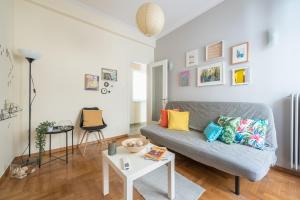 a living room with a couch and a table at Sweet home in Koukaki in Athens