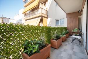a patio with potted plants and a building at Keramikos metro st luxury studio for 2 by MPS in Athens