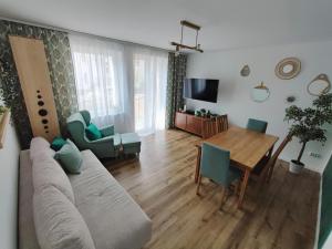 a living room with a couch and a table at ablotu - 2-8 person, parking,garden in Świnoujście