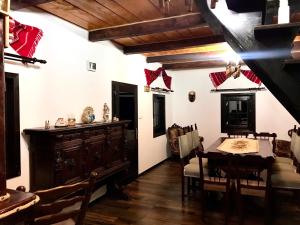 a living room with a table and a dining room at Casa Gabriel in Frumosu