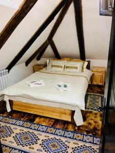 a bedroom with a bed in a attic at Casa Gabriel in Frumosu