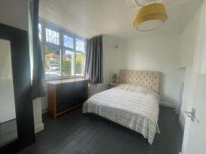 a small bedroom with a bed and a window at Cozy bungalow in great location 