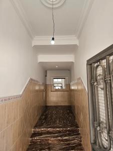 a walkway in a bathroom with a ceiling and a window at Résidence Anouar in Tétouan