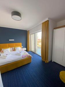 a hotel room with a bed and a large window at Apartamenty Mistral in Jastarnia