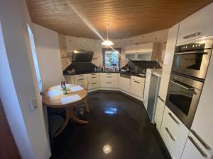 a small kitchen with a small table and a stove at Frankfurt Close Apartment in Hainburg