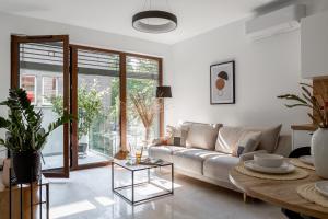 a living room with a couch and a table at Apartamenty In Belnihel in Hel +164 photos