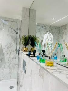 a bathroom with a counter with plants and a mirror at Executive Apartment’s Mk in Milton Keynes