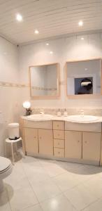 a bathroom with two sinks and a mirror and a toilet at Villa Marbesa Beach in Marbella