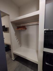 a white cupboard with wine racks in a kitchen at Meridiano in Parikia