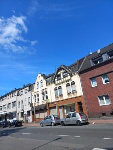 a city street with cars parked in front of buildings at hoteliving Duisburg-Moers in Duisburg