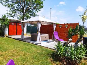 a patio with an umbrella and purple chairs at Kuća Lilla in Loborika +90 photos