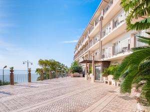 a cobblestone street in front of a building at Hotel Antares in Letojanni